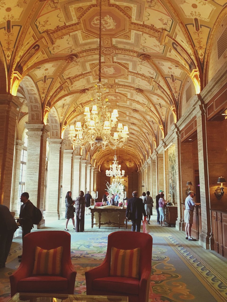 indoors, religion, place of worship, ceiling, spirituality, men, arch, person, architectural column, interior, architecture, church, corridor, sitting, lifestyles, built structure, pew