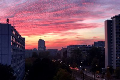 Modern buildings against sky during sunset