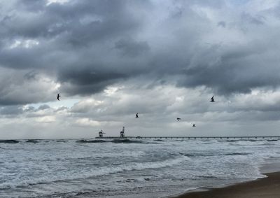 Scenic view of sea against cloudy sky