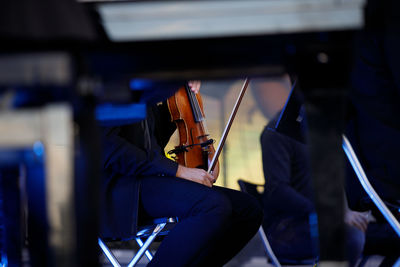 Musician holding violin on stage