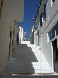 Steps amidst buildings in town against clear sky