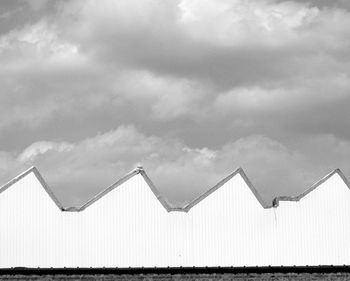 Low angle view of built structure on beach against sky