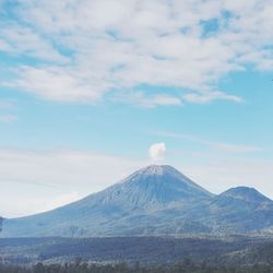 View of volcanic landscape against cloudy sky