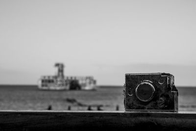 Close-up of old ship in sea against clear sky