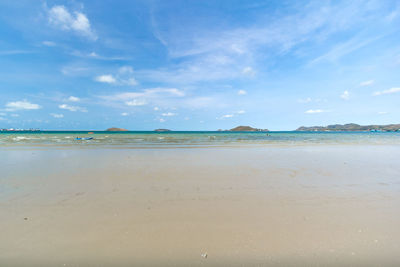 Scenic view of beach against blue sky