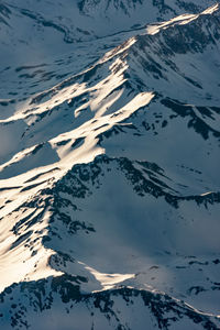 High angle view of snowcapped mountains against sky