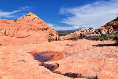 Rock formations on landscape against sky