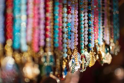 Colorful beads hanging at market for sale