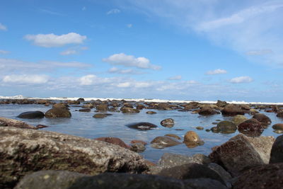 Rocks on beach against sky