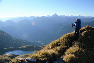 Man standing on mountain against sky