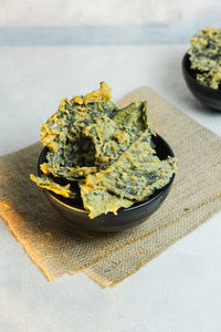 Crispy and savory spinach chips. made from spinach leaves and rice flour. homemade snack.