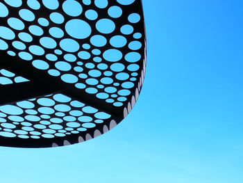 Low angle view of ceiling against clear blue sky