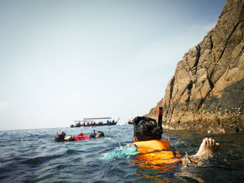 Rear view of girl swimming in sea