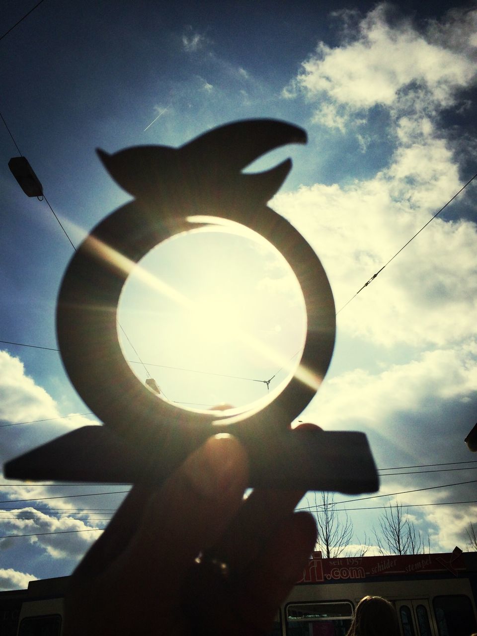 sky, low angle view, part of, person, cloud - sky, sunlight, sun, built structure, airplane, cropped, cloud, sunbeam, flying, glass - material, air vehicle, lens flare, architecture, silhouette