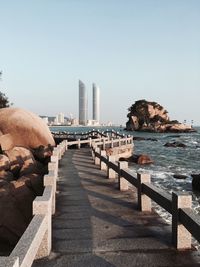 Bridge over sea against clear sky