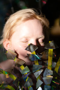 Close-up of young woman using decorations 