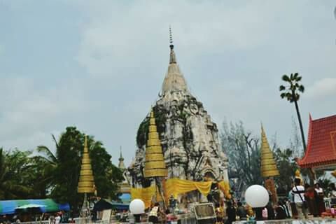 religion, place of worship, spirituality, temple - building, sky, tree, building exterior, built structure, architecture, travel destinations, cultures, tourism, famous place, temple, travel, tradition, low angle view, palm tree, incidental people