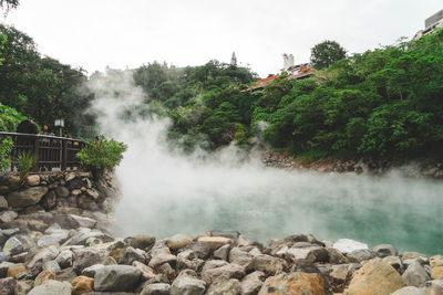 Scenic view of waterfall against sky