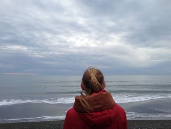 Rear view of woman looking at sea against sky