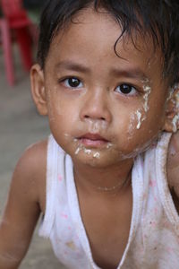 Close-up portrait of cute boy with messy face