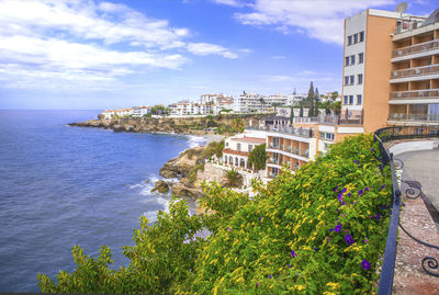 Scenic view of sea and buildings against sky