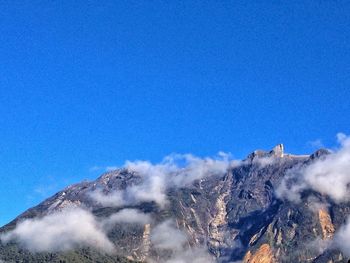 Scenic view of mountains against clear blue sky