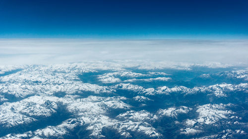 Aerial view of landscape against blue sky