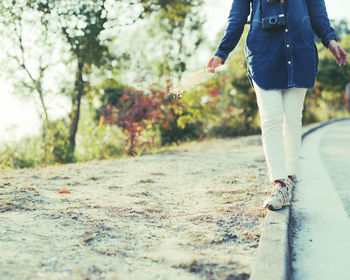 Low section of people walking on road