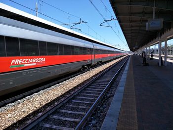 Train at railroad station against sky