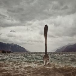 Scenic view of sea against cloudy sky