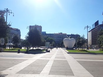 View of city street against blue sky