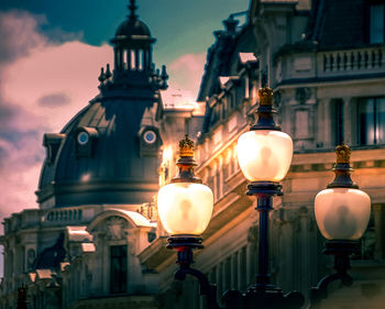 Close-up of illuminated street light against building