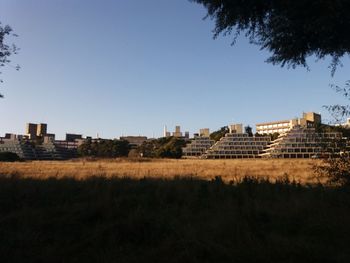 Buildings in city against clear sky