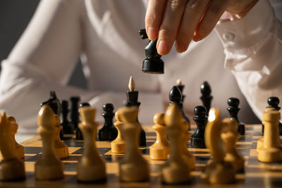 Midsection of woman playing chess