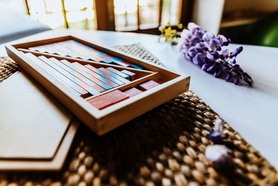 Close-up of toy blocks by purple flowers on table