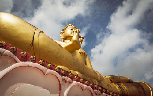 Giant sitting buddha on rang hill temple wat khao rang with blue sky in phuket, thailand