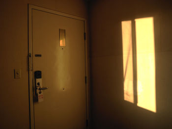 Sunlight streaming through closed door of building