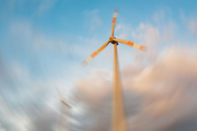 Low angle view of traditional windmill against sky