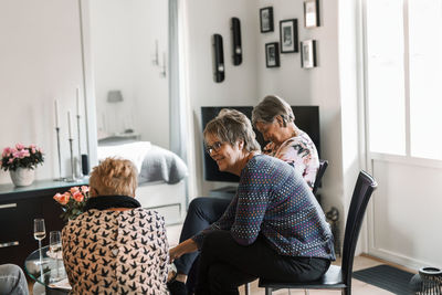 Group of people sitting in kitchen