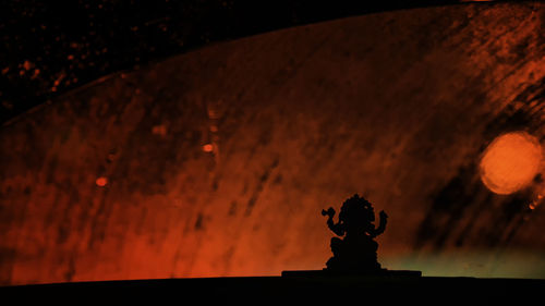 Close-up of statue against sky at night