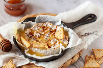 Camembert soft french cheese cooked in the oven with honey and thyme