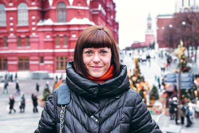 Portrait of smiling young woman in city