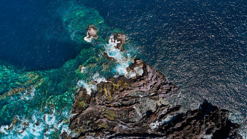 A view over the water of the atlantic ocean in tenerife island spain volcanic rocks