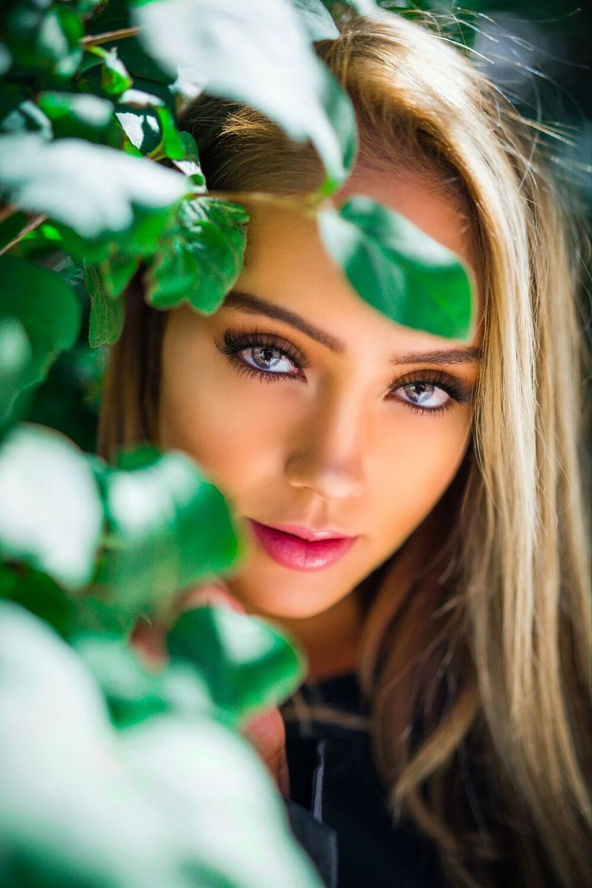 CLOSE-UP PORTRAIT OF A YOUNG WOMAN WITH HAIR