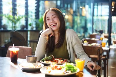 Portrait of young woman sitting at restaurant