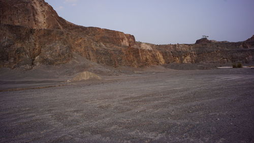 Scenic view of arid landscape against sky