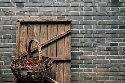 Wicker basket hanging on brick wall