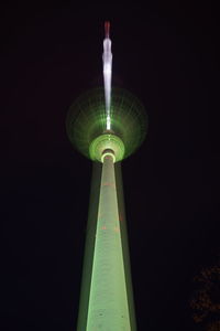Low angle view of illuminated tower against sky at night