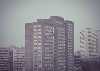 Buildings in city against clear sky