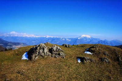 Scenic view of mountains against blue sky